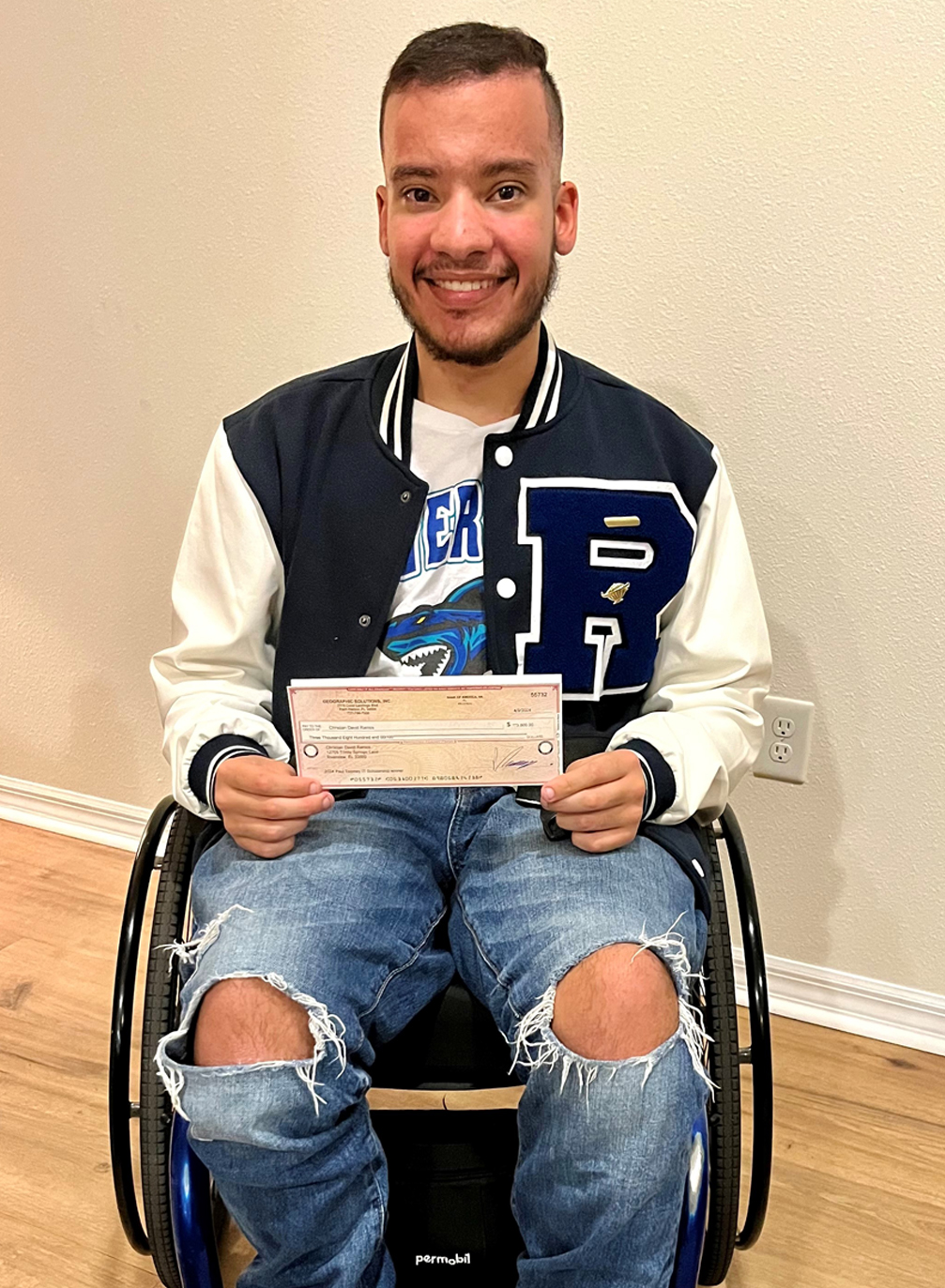 Christian Ramos holding IT Scholarship Award check